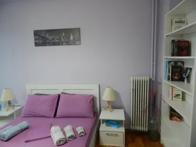 a bedroom with a purple bed with shoes on it at Feels Like Home 2 in Athens