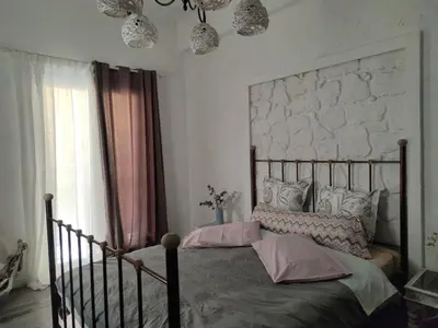 a bedroom with a large bed with pink pillows at Unique Luxury House in Athens