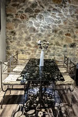 a table in a room with a stone wall at Unique Luxury House in Athens