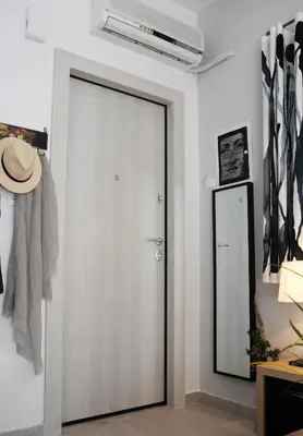 a door in a room with a hat and a mirror at Top of the city Central studio with Acropolis View in Athens