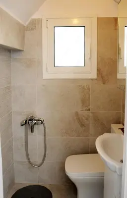 a bathroom with a toilet and a window at Top of the city Central studio with Acropolis View in Athens