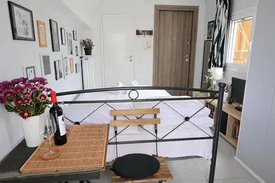a room with a bed and a table with wine bottles at Top of the city Central studio with Acropolis View in Athens
