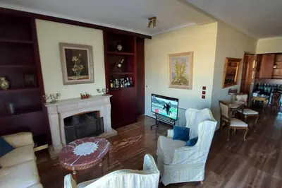 a living room with a fireplace and a tv at METROPOLITAN Macview -2 in Piraeus