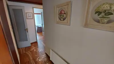 a hallway with a white wall with two pictures on it at METROPOLITAN Macview -2 in Piraeus