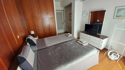 a small bedroom with a bed and a television at METROPOLITAN Macview -2 in Piraeus