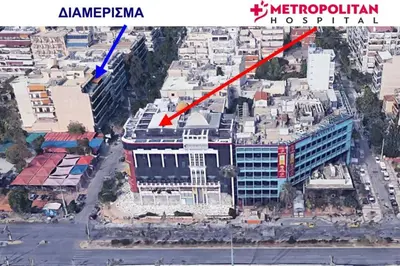 an aerial view of a city with a red arrow at METROPOLITAN Macview -2 in Piraeus