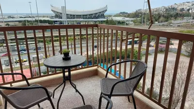 a patio with a table and chairs on a balcony at METROPOLITAN Macview -2 in Piraeus