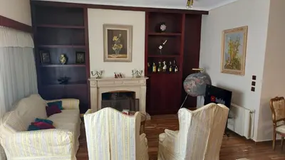a living room with two chairs and a fireplace at METROPOLITAN Macview -2 in Piraeus