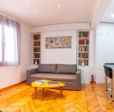 a living room with a couch and a table at Martin's Akropolis Studio in Athens