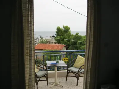 a view of a balcony with a table and chairs at Helios Hotel in Agia Marina Aegina