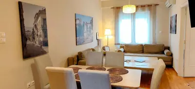 a living room with a table and a couch at Acropolis museum grand apartment in Athens