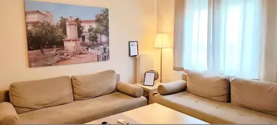 a living room with a couch and a table at Acropolis museum grand apartment in Athens