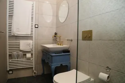 a bathroom with a sink and a toilet at Rooster Suites in Athens