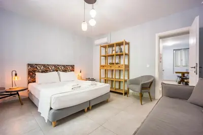 a bedroom with a bed and a desk and a chair at Bentzi...Boutique Apartment in Pangrati, Superior Suite (2) for 4 guests in Athens