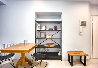 a dining room with a table and a shelf at Bentzi...Boutique Apartment in Pangrati, Superior Suite (2) for 4 guests in Athens