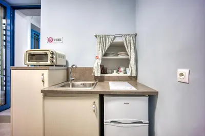 a small kitchen with a sink and a microwave at Bentzi...Boutique Apartment in Pangrati, Superior Suite (2) for 4 guests in Athens