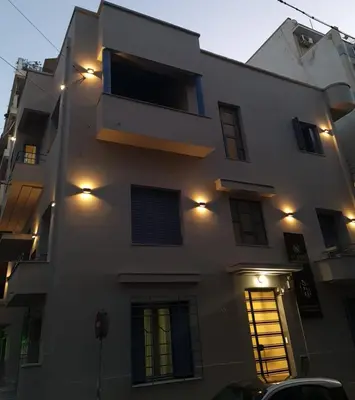 a white building with lights on the side of it at Bentzi...Boutique Apartment in Pangrati, Superior Suite (2) for 4 guests in Athens