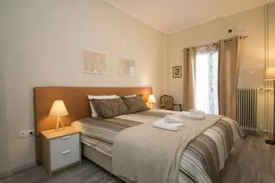 a bedroom with a large bed and a window at Relaxing by Acropolis in Athens
