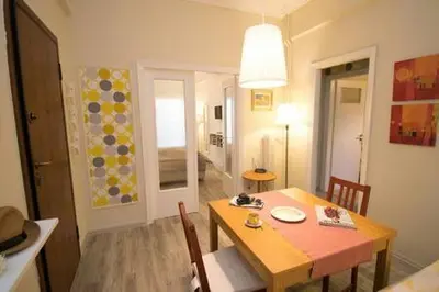 a dining room with a table and chairs and a room with a dining room at Relaxing by Acropolis in Athens