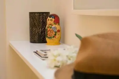 a shelf with a vase and flowers on it at Relaxing by Acropolis in Athens