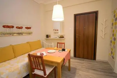 a living room with a table and a couch at Relaxing by Acropolis in Athens