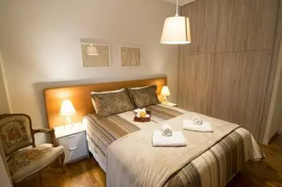 a bedroom with a bed with two towels on it at Relaxing by Acropolis in Athens