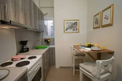 a kitchen with a stove and a table in it at Relaxing by Acropolis in Athens