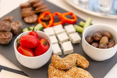 a tray of food with bowls of vegetables and pretzels at The Painters Luxurious villa in Anavissos