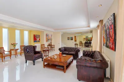 a living room with couches and chairs and a table at The Painters Luxurious villa in Anavissos