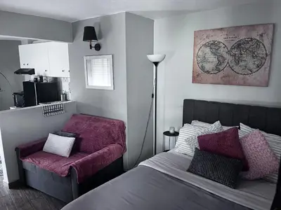 a bedroom with a bed and a chair in it at Cozy studio apartment in the heart of Athens in Athens