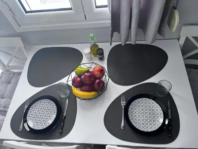 a table with a bowl of fruit on top of it at Cozy studio apartment in the heart of Athens in Athens