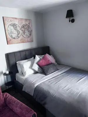 a bed with pillows on it in a bedroom at Cozy studio apartment in the heart of Athens in Athens