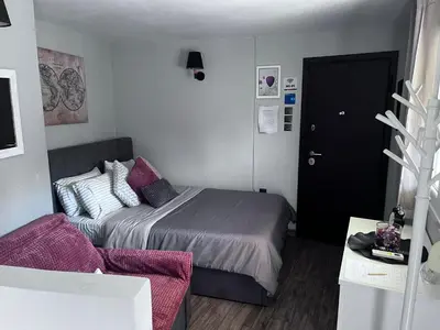 a small bedroom with a bed and a couch at Cozy studio apartment in the heart of Athens in Athens