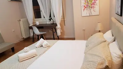 a bedroom with a bed with towels and a piano at Olive Apartment- Athens Center, 4 BD, 1.5 BATH in Athens