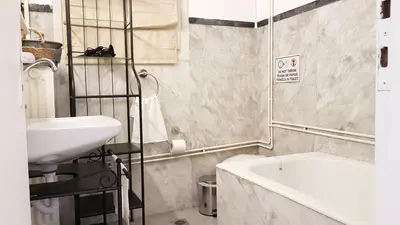 a bathroom with a sink and a bath tub at Olive Apartment- Athens Center, 4 BD, 1.5 BATH in Athens