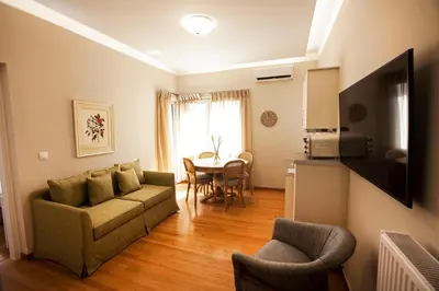 a living room with a couch and a table at Bentzi Boutique Apartment 4 in Athens