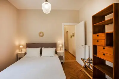 a bedroom with a large bed and two night stands at Bentzi Boutique Apartment 4 in Athens