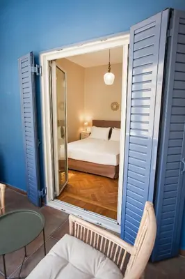 a view of a bedroom with a bed through a window at Bentzi Boutique Apartment 4 in Athens