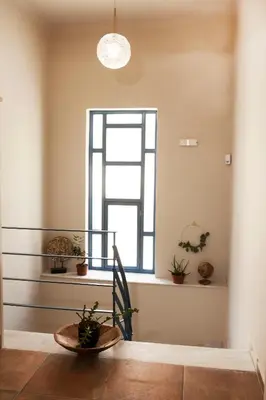 a room with a window and a table with plants at Bentzi Boutique Apartment 4 in Athens