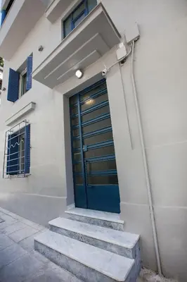 a blue door on the side of a building at Bentzi Boutique Apartment 4 in Athens