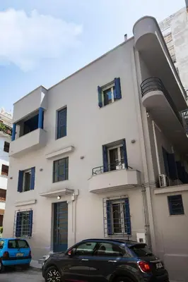 a black car parked in front of a building at Bentzi Boutique Apartment 4 in Athens