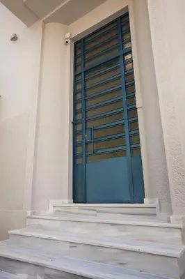 a blue door on the side of a building at Bentzi...Boutique Apartment 6, Superior Suite for 4 Guests in Athens