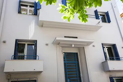 a white building with blue windows and a door at Bentzi...Boutique Apartment 6, Superior Suite for 4 Guests in Athens