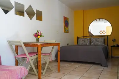 a bedroom with a desk and a bed and a table at Cosy guest house with private yard in Saronida
