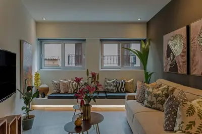 a living room with a couch and windows at Living Stone Amazonit in Athens