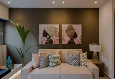 a couch in a living room with three pictures on the wall at Living Stone Amazonit in Athens