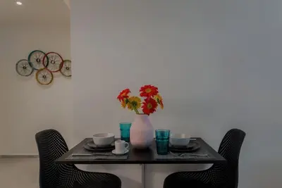 a table with a vase with flowers on it at Living Stone Amazonit in Athens