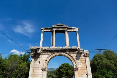 a stone arch with pillars on top of it at Plato's Square Apartments in Athens