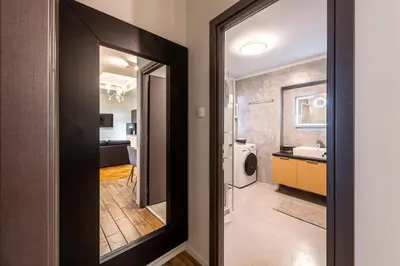 a bathroom with a mirror and a sink in a room at Modern 5BD Apartment in the Heart of Athens in Athens