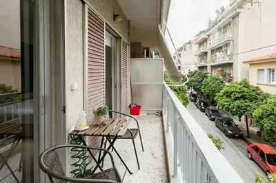 a balcony with a table and chairs on a balcony at Koukaki Studio with a Sunny Balcony, near the Acropolis in Athens